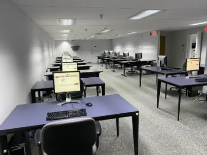 Inside of the Test Spots Testing Center with desks and computers.